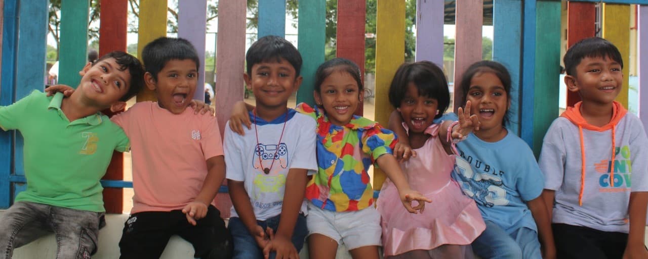 Happy children at school with colorful fence